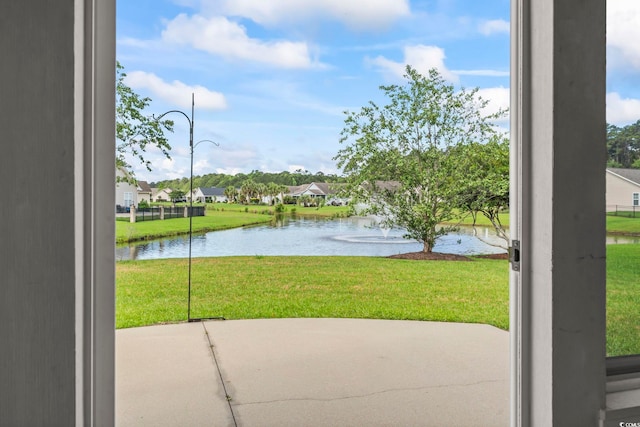 doorway featuring a water view and a residential view