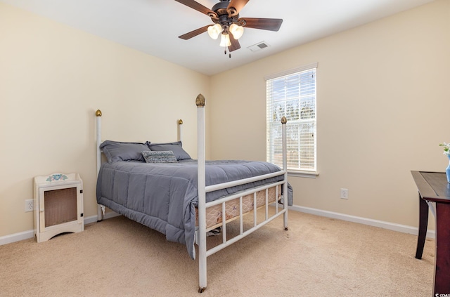 carpeted bedroom with baseboards and ceiling fan