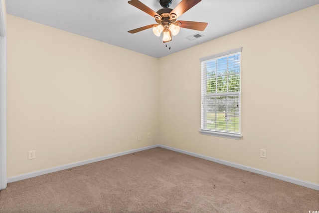 empty room featuring light carpet, baseboards, and ceiling fan