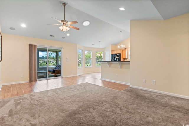 unfurnished living room with ceiling fan, light wood finished floors, baseboards, a chandelier, and recessed lighting