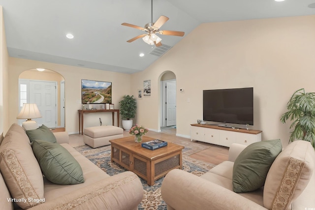 living room featuring arched walkways, a ceiling fan, baseboards, high vaulted ceiling, and recessed lighting