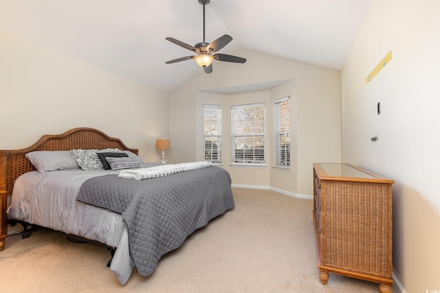 bedroom with lofted ceiling, light carpet, a ceiling fan, and baseboards