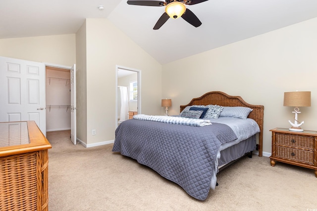 bedroom featuring vaulted ceiling, light colored carpet, a spacious closet, baseboards, and a closet