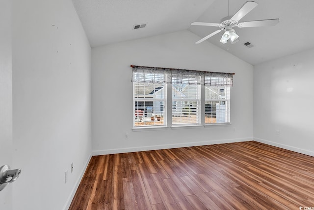 unfurnished room featuring wood-type flooring, a textured ceiling, ceiling fan, and lofted ceiling