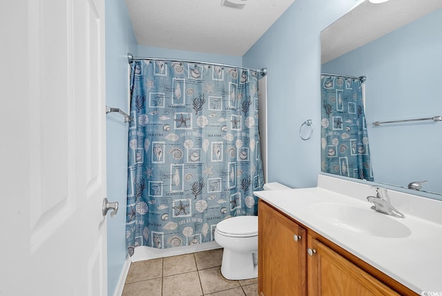 bathroom with vanity, tile patterned flooring, toilet, a textured ceiling, and curtained shower