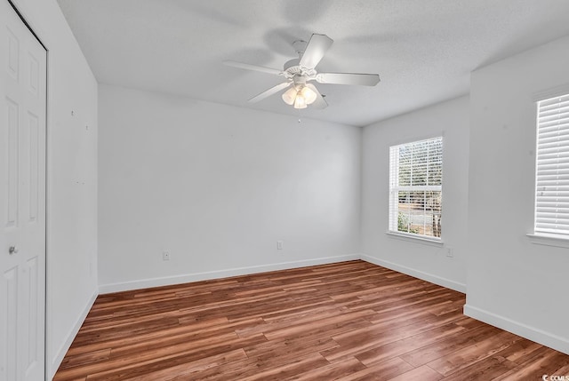 unfurnished room with hardwood / wood-style floors, ceiling fan, and a textured ceiling