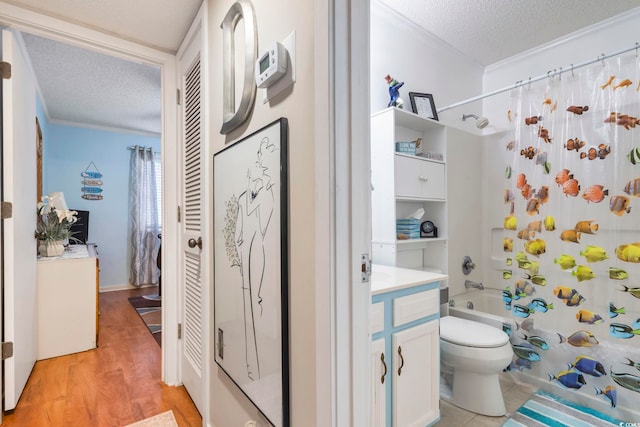 full bathroom with vanity, a textured ceiling, hardwood / wood-style flooring, and shower / bathtub combination with curtain