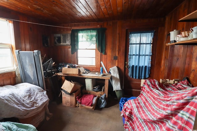 interior space with a healthy amount of sunlight, wood ceiling, carpet floors, and wooden walls