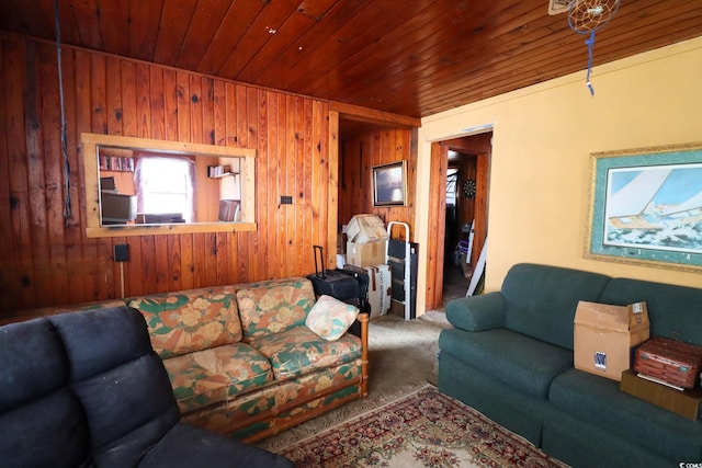 carpeted living room with wooden walls and wooden ceiling