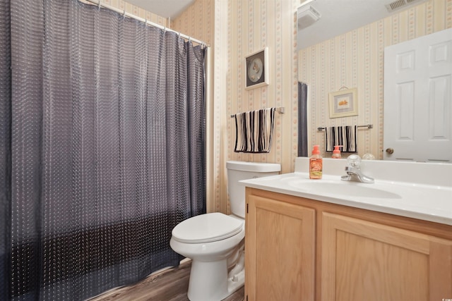 bathroom featuring wood-type flooring, a shower with shower curtain, vanity, and toilet