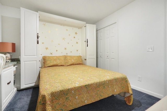 bedroom featuring a closet and dark colored carpet