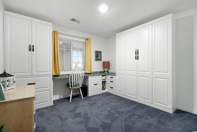 office featuring built in desk and dark colored carpet