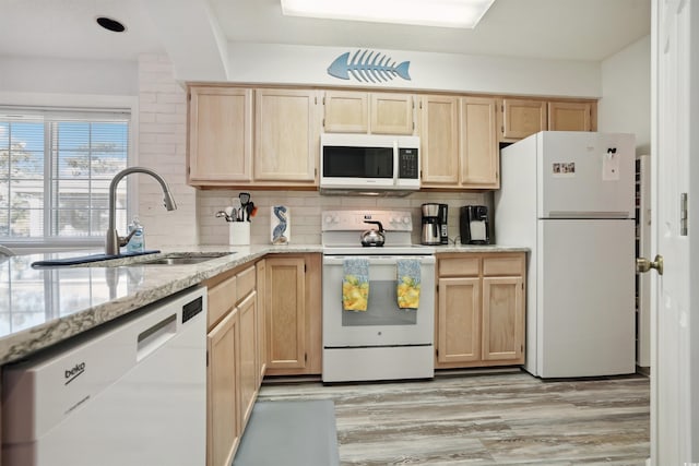 kitchen featuring sink, white appliances, tasteful backsplash, light brown cabinetry, and light stone countertops