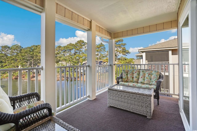 sunroom / solarium featuring a water view and plenty of natural light