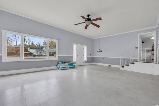 interior space with ceiling fan and ornamental molding