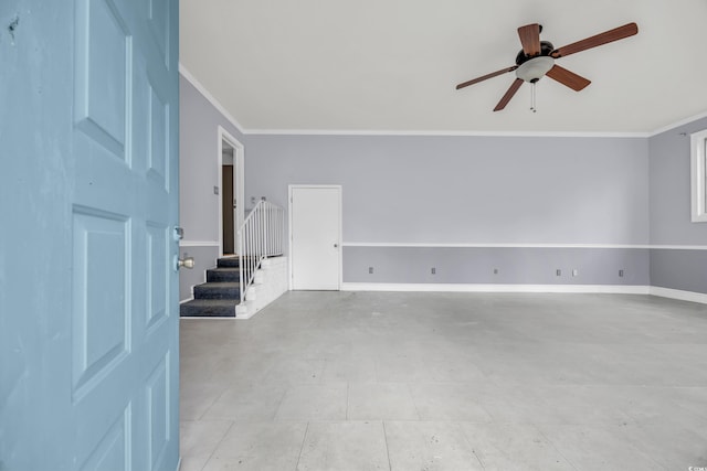 interior space with ceiling fan and crown molding