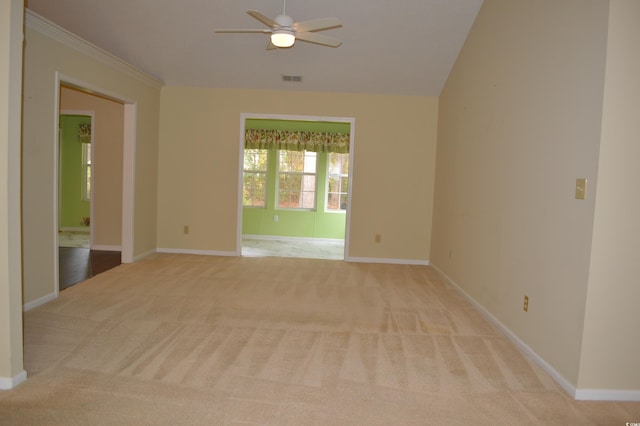 unfurnished room with light carpet, ceiling fan, and vaulted ceiling