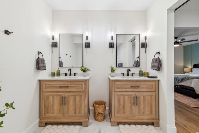 bathroom with hardwood / wood-style flooring, ceiling fan, and vanity