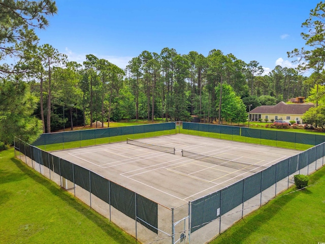 view of sport court with a lawn