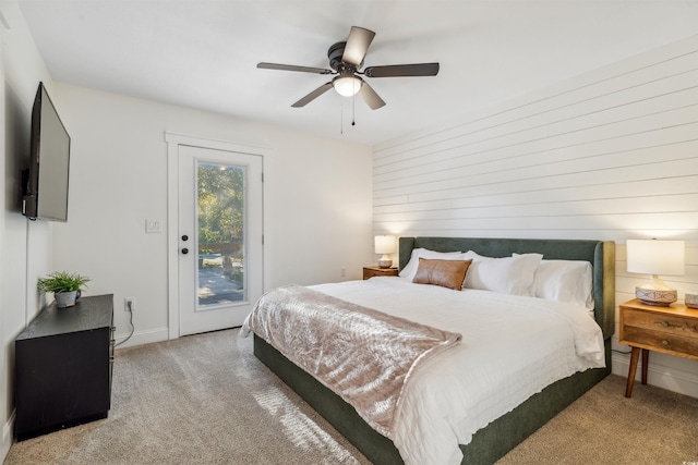 carpeted bedroom with ceiling fan and access to exterior