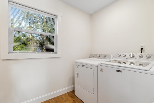 clothes washing area with light hardwood / wood-style floors and independent washer and dryer