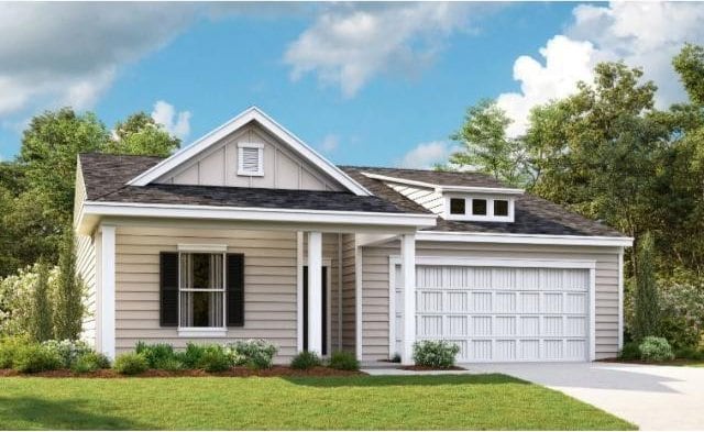 view of front of property with a front yard and a garage