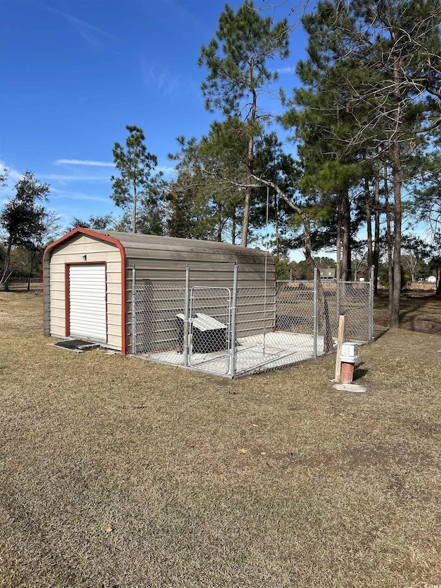 view of outdoor structure featuring a lawn