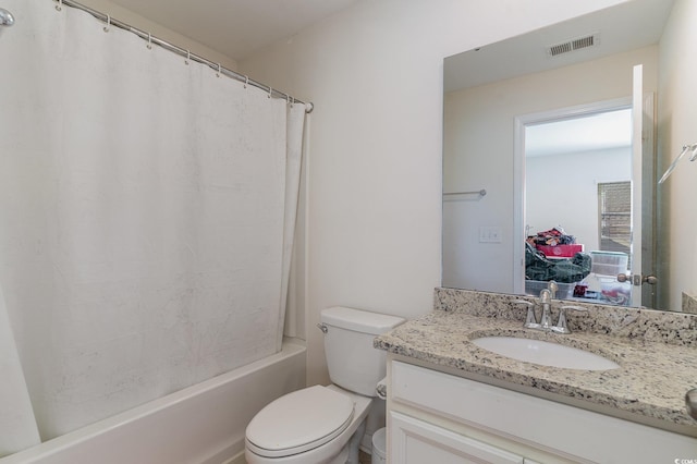 full bathroom with vanity, shower / bath combination with curtain, and toilet