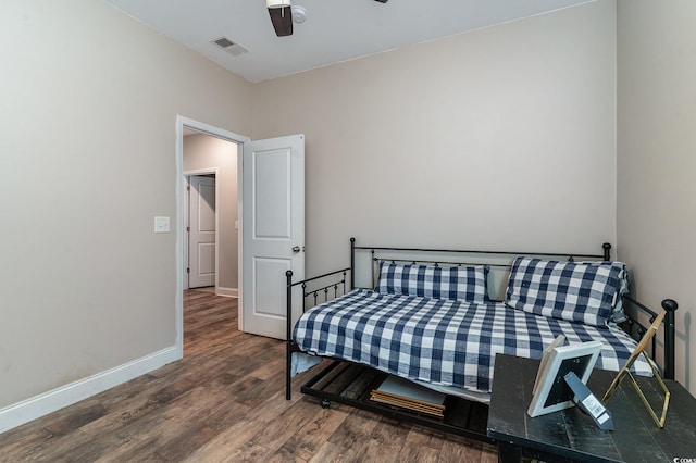 bedroom with ceiling fan and dark wood-type flooring