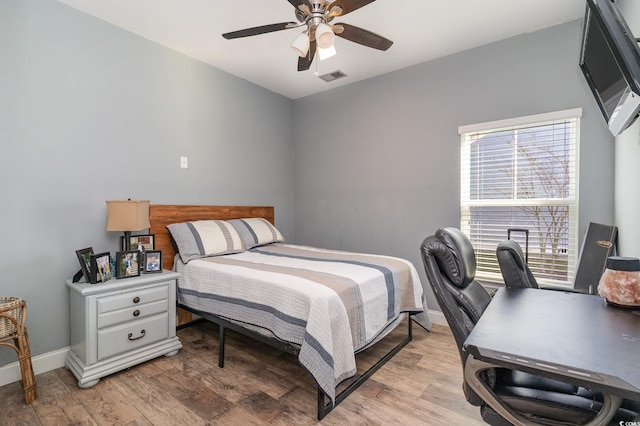 bedroom with light hardwood / wood-style flooring and ceiling fan