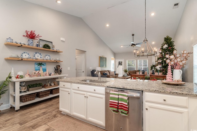 kitchen featuring light stone countertops, white cabinetry, dishwasher, sink, and light hardwood / wood-style flooring