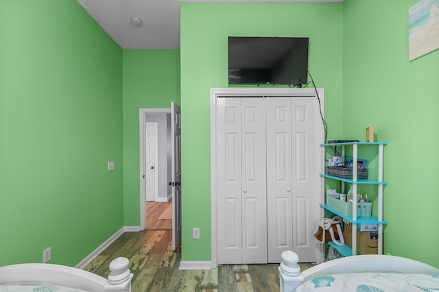 bedroom featuring hardwood / wood-style floors and a closet