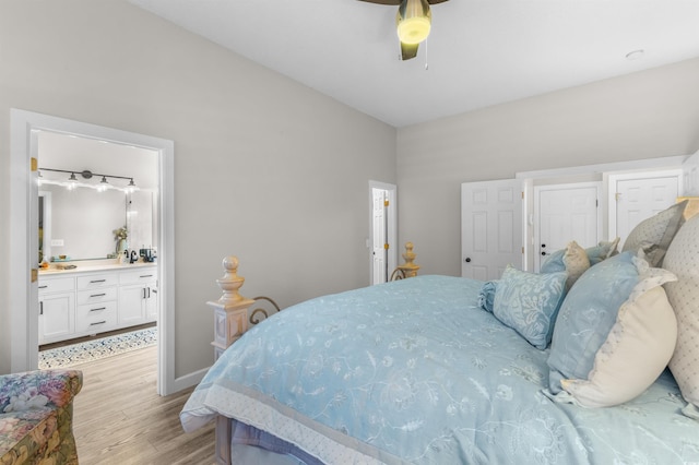 bedroom featuring light hardwood / wood-style flooring, ensuite bath, and ceiling fan