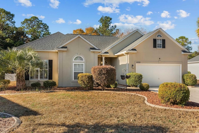 view of front facade featuring a front yard and a garage