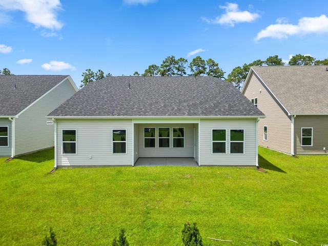 back of house with a yard and a patio