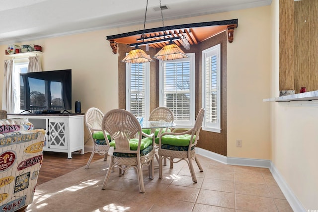 tiled dining room with crown molding