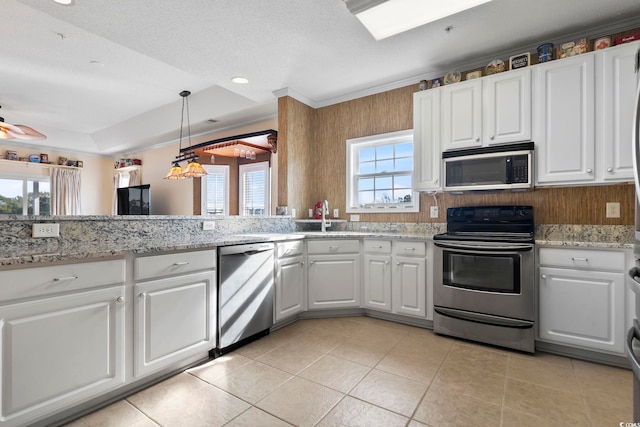 kitchen with white cabinets, pendant lighting, a textured ceiling, and appliances with stainless steel finishes