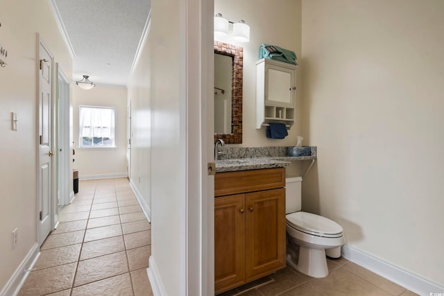 bathroom featuring tile patterned floors, a textured ceiling, vanity, crown molding, and toilet