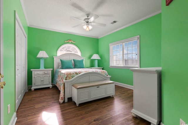 bedroom with multiple windows, a closet, ceiling fan, and dark hardwood / wood-style floors