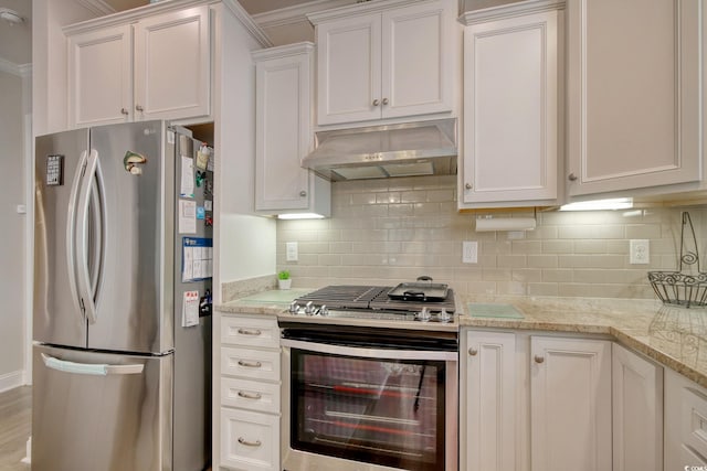 kitchen with tasteful backsplash, white cabinets, stainless steel appliances, and ventilation hood