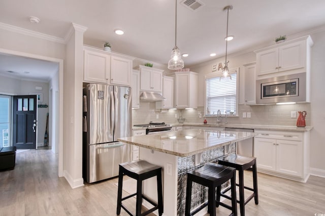 kitchen featuring white cabinetry, a center island, light hardwood / wood-style flooring, and appliances with stainless steel finishes