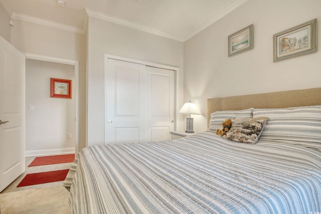 carpeted bedroom with a closet and crown molding