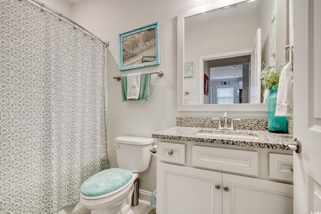 bathroom featuring vanity and toilet