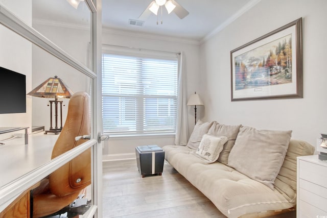 living room featuring crown molding, ceiling fan, and light wood-type flooring