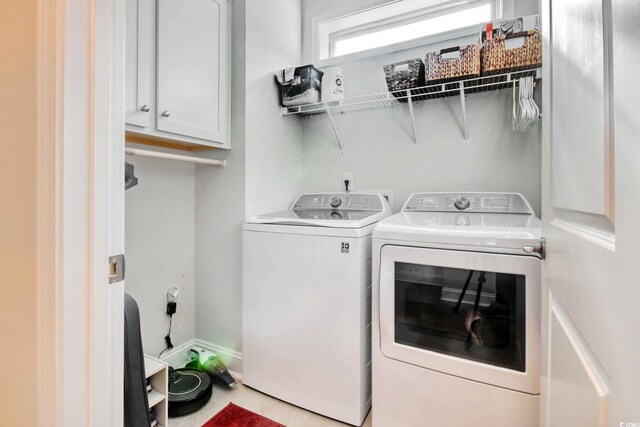 washroom featuring cabinets and independent washer and dryer