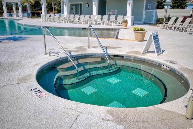 view of pool featuring a patio area and a hot tub