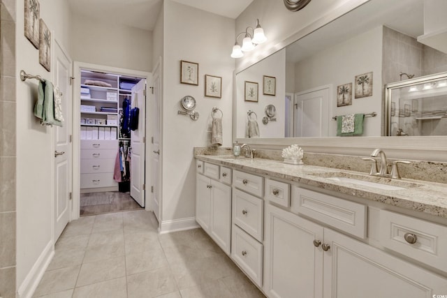 bathroom featuring tile patterned floors, vanity, and walk in shower