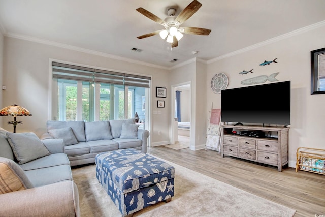 living room with hardwood / wood-style floors, ceiling fan, and crown molding