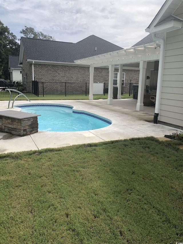 view of pool featuring a lawn and a patio