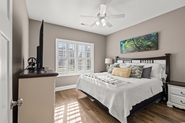 bedroom with ceiling fan and dark wood-type flooring